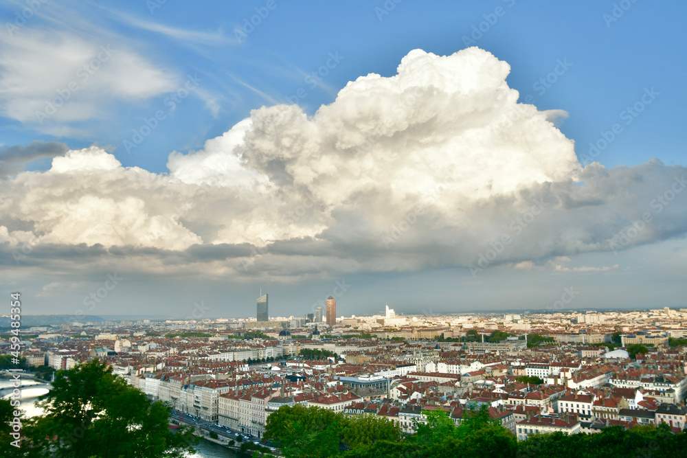 Impressive view of the city of Lyon dominated by a gigantic cloud at the end of the day in Rhone Alpes, France.