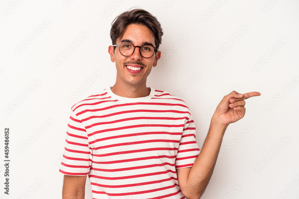 Young mixed race man isolated on white background smiling cheerfully pointing with forefinger away. Young mixed race man isolated on white background smiling cheerfully pointing with forefinger away.