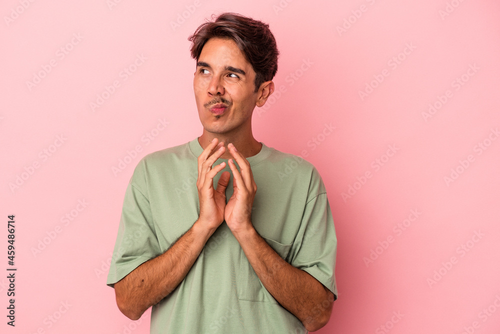 Young mixed race man isolated on white background making up plan in mind, setting up an idea. Young mixed race man isolated on white background making up plan in mind, setting up an idea.