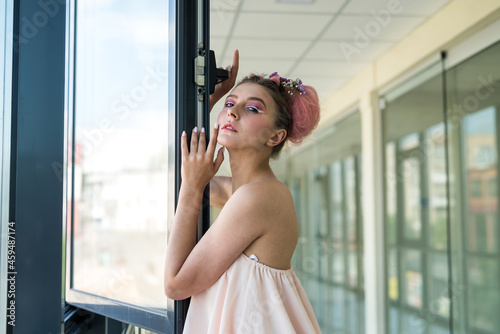 Fashion portrait of beautiful woman posing near open window Free Download Fashion portrait of beautiful woman posing near open window - GFXLoad