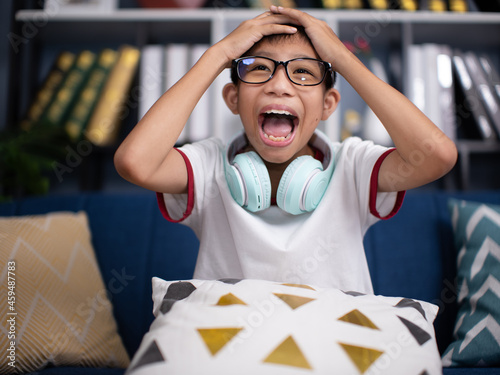 asian boy very excited, passionate, satisfied with something.