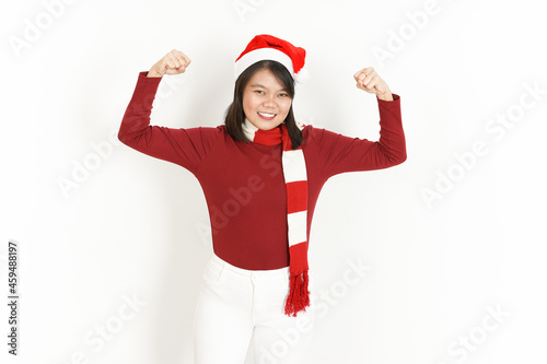 Showing strength and rise arms Beautiful Asian Woman Wearing Red Turtleneck and Santa Hat Isolated On White Background
