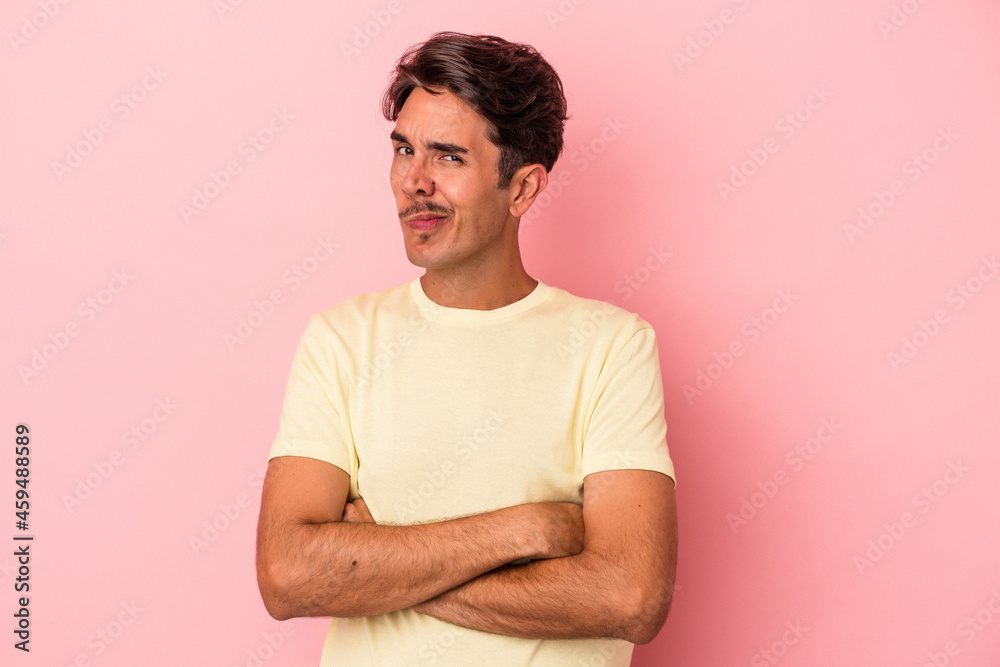 Young mixed race man isolated on white background unhappy looking in camera with sarcastic expression.