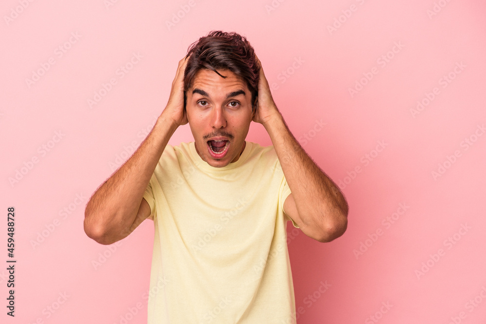 Young mixed race man isolated on white background screaming, very excited, passionate, satisfied with something. Young mixed race man isolated on white background screaming, very excited, passionate, satisfied with something.