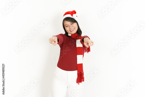 Smile And Pointing At You of Beautiful Asian Woman Wearing Red Turtleneck and Santa Hat Isolated On White Background