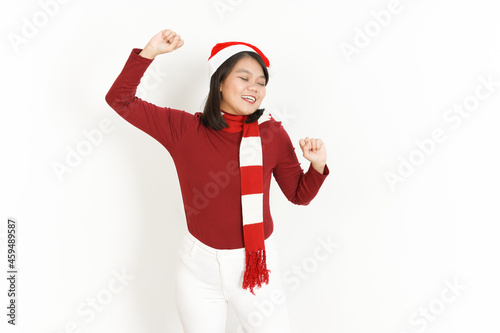 Dance Gesture of Beautiful Asian Woman Wearing Red Turtleneck and Santa Hat Isolated On White Background