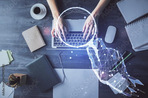 Double exposure of woman hands working on computer and creative hologram drawing. Top View. Start up concept.