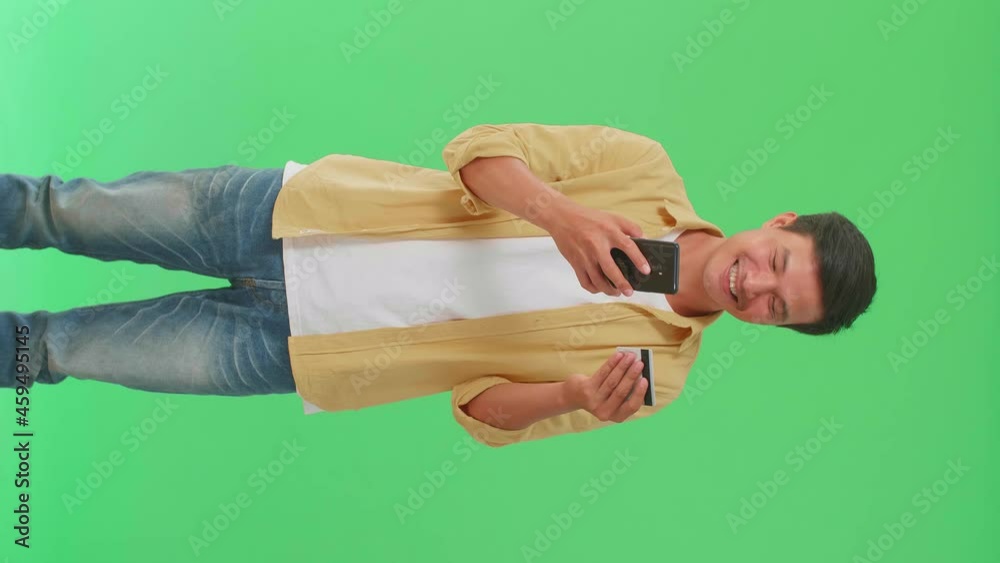 Asian Man Using Mobile Phone With Credit Card And Celebrating In The Green Screen Studio
Asian Man Using Mobile Phone With Credit Card And Celebrating In The Green Screen Studio