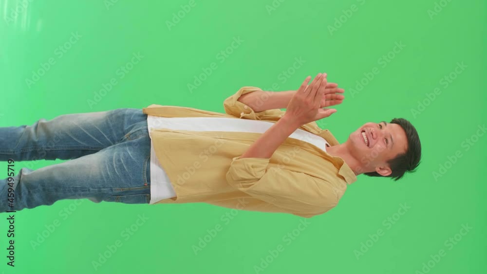 Young Asian Man Clapping Her Hands In The Green Screen Studio
Young Asian Man Clapping Her Hands In The Green Screen Studio