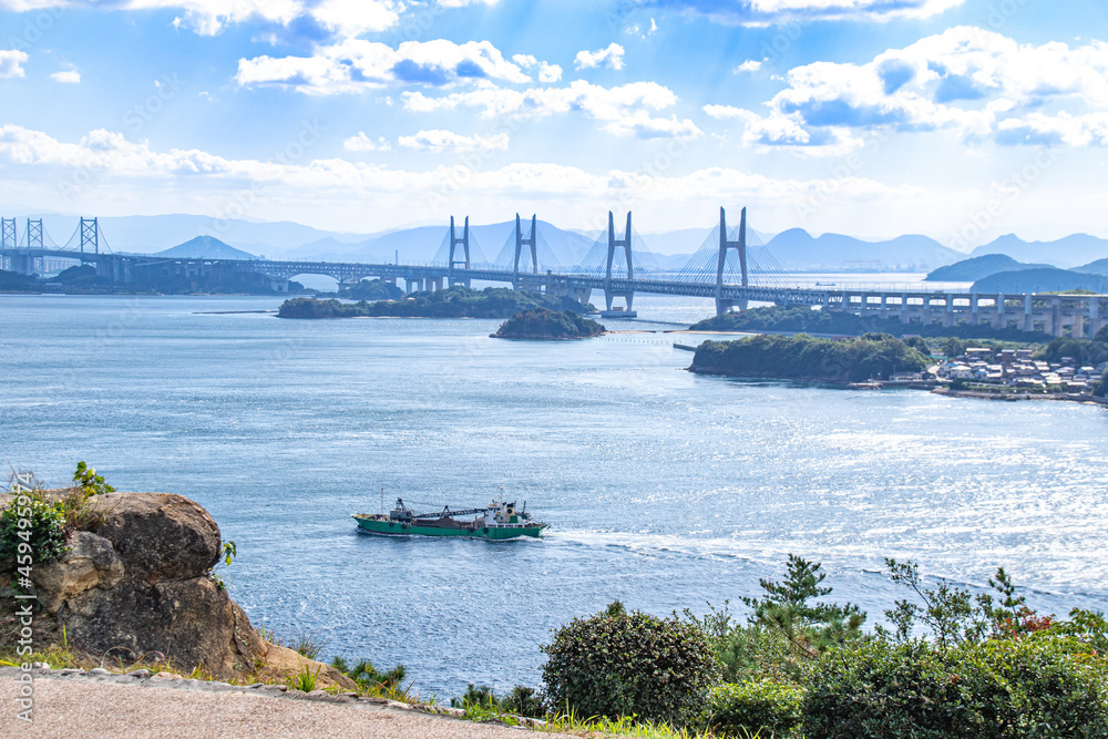 瀬戸大橋と船の風景　岡山県倉敷市　The view of Seto Ohashi bridge at Setonaikai, Inland Sea of Japan, and a freight vessel in Kurashiki city, Okayama pref. Japan
