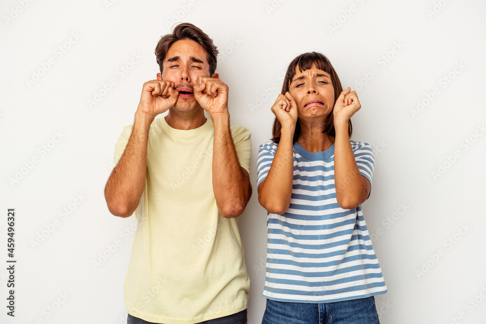 Young mixed race couple isolated on white background whining and crying disconsolately. Young mixed race couple isolated on white background whining and crying disconsolately.
