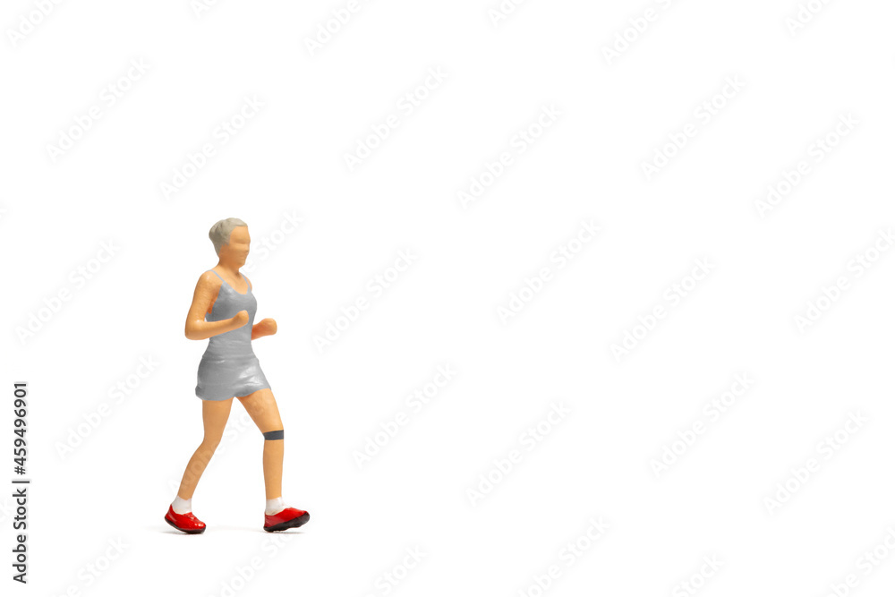 Miniature people, Woman in fitness wear running on white background Miniature people, Woman in fitness wear running on white background