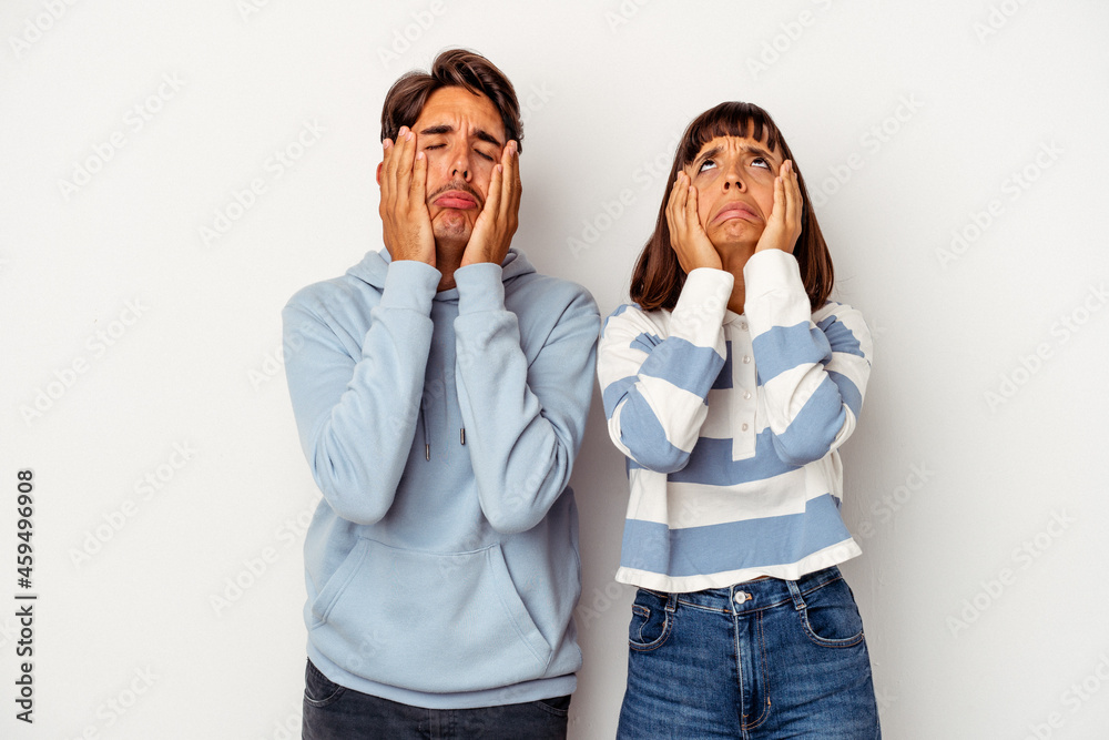 Young mixed race couple isolated on white background whining and crying disconsolately. Young mixed race couple isolated on white background whining and crying disconsolately.