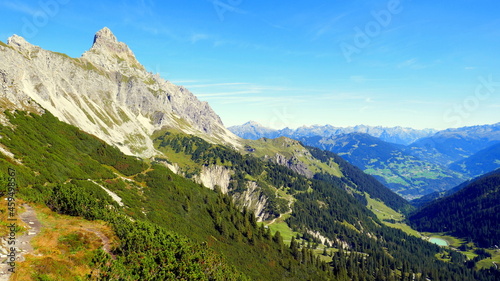 Gipfel der Zimba im Vorarlberg mit weitem Blick ins Montafon mit grünen Tälern unter blauem Himmel photo