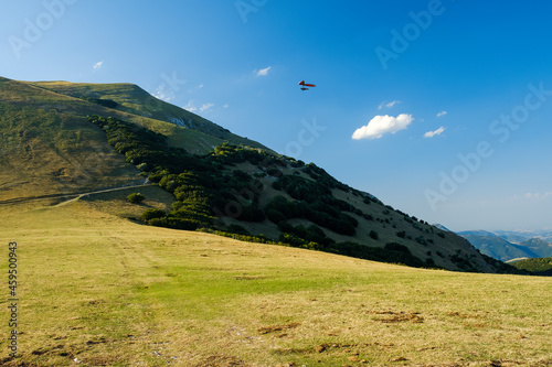 Hang glider just after launch from Monte Cucco Regional Park, Umbria, Italy photo