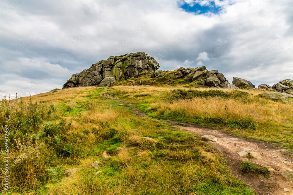 A view looking up to the summit of the Almscliffe crag in Yorkshire, UK in summertime