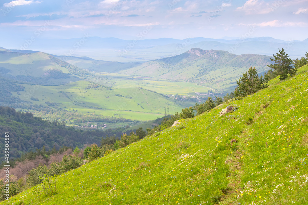 A barely noticeable path leads along a grassy hillside in the countryside A barely noticeable path leads along a grassy hillside in the countryside