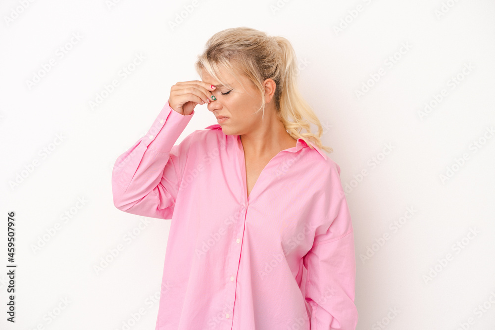 Young Russian woman isolated on white background having a head ache, touching front of the face. Young Russian woman isolated on white background having a head ache, touching front of the face.