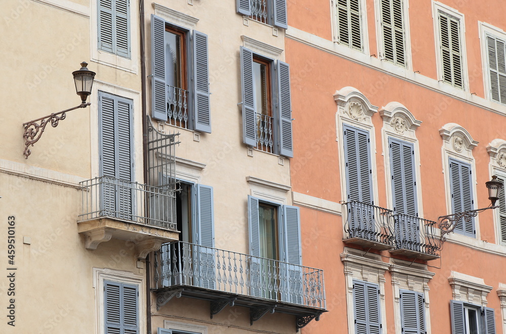 Typical Building Facades with Balconies, Grey Shutters and Lanterns in Rome, Italy