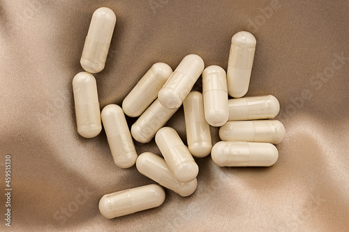 n-acetyl cysteine (NAC) supplement capsules  on silk background. mental wellbeing and personal health concept