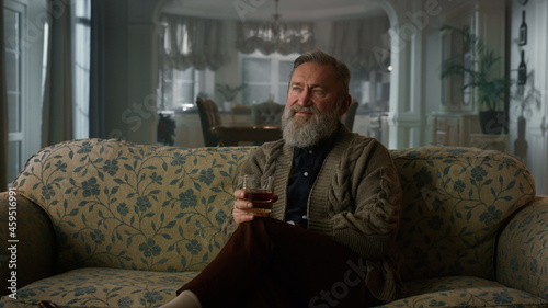 Rich senior man enjoy retirement life cognac. Confident old gentleman drinking