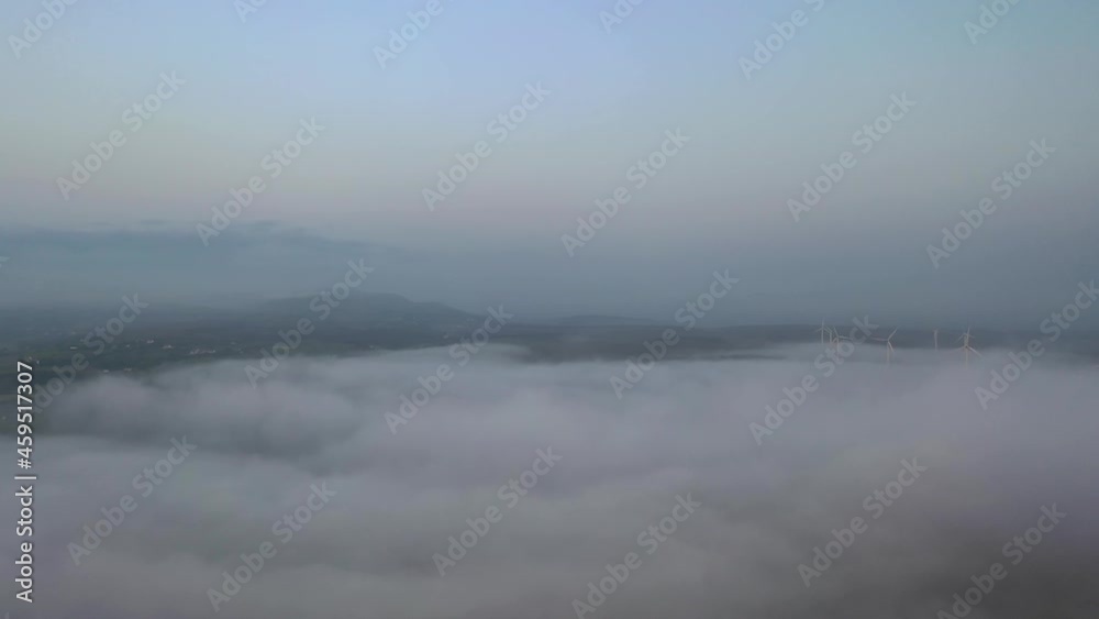 Fog rolling in at Wind Power turbines at the irish coast at Portnoo, County Donegal - Ireland Fog rolling in at Wind Power turbines at the irish coast at Portnoo, County Donegal - Ireland