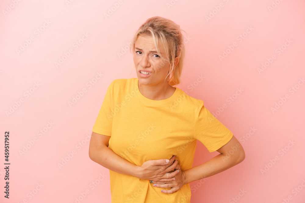 Young Russian woman isolated on pink background having a liver pain, stomach ache. Young Russian woman isolated on pink background having a liver pain, stomach ache.