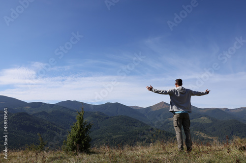 Man enjoying picturesque view of mountain landscape on sunny day © New Africa