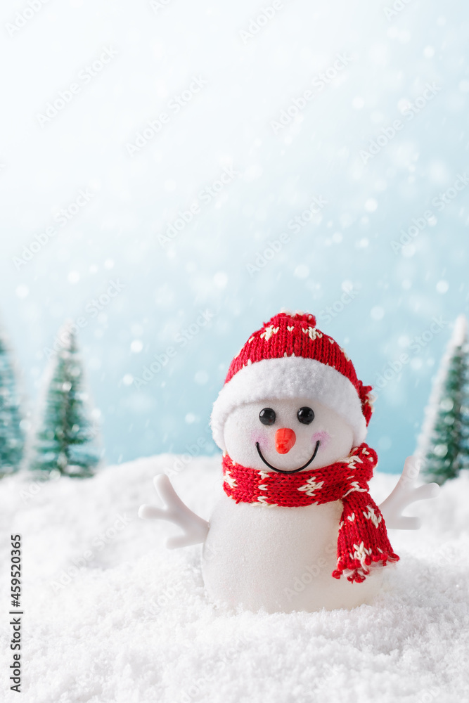 Christmas background with happy snowman standing in winter landscape. Christmas greeting card. Winter time.