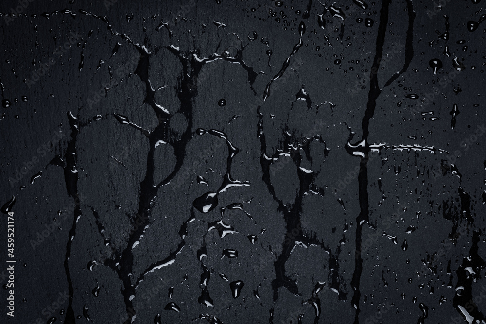 Fototapeta premium Water on dark stone surface