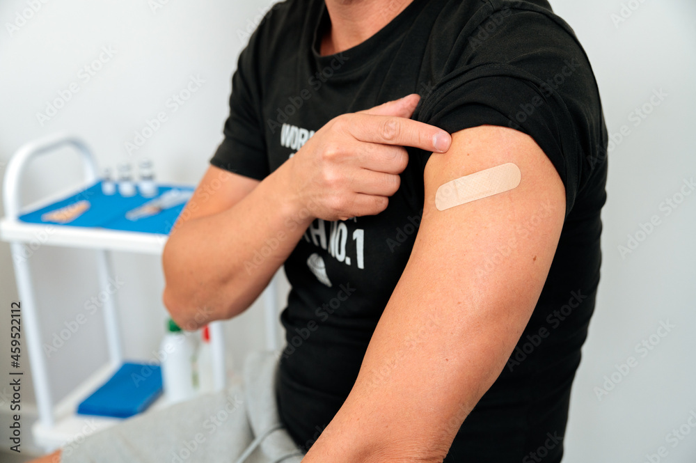 Smiling Covid vaccinated man in clinic Smiling Covid vaccinated man in clinic