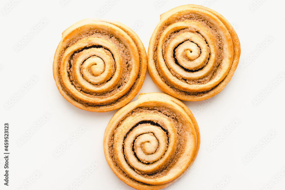 Cinnamon rolls on a white plate. Snail buns. Sweet pastries. 