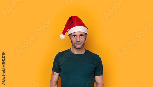 Young man with Christmas hat and a funny expression