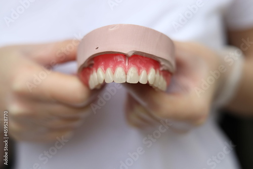 dentist holding denture