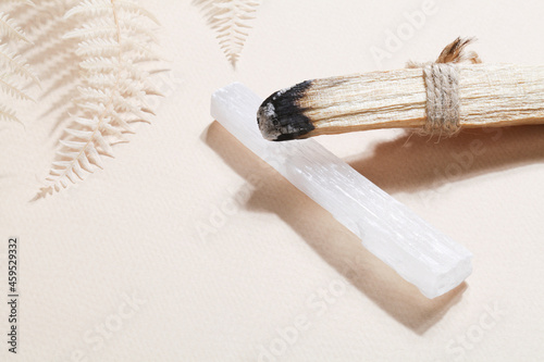 Palo Santo stick, selenite on beige background photo