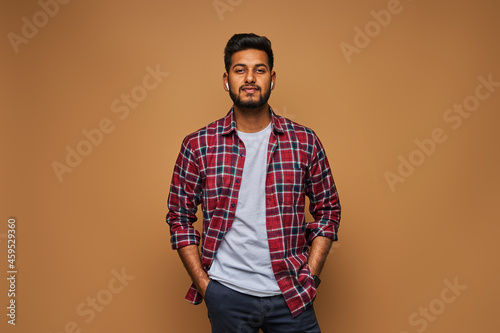 Stylish handsome indian man in tshirt on pastel background