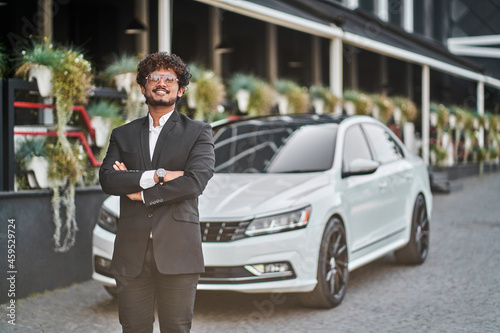 Tall Indian businessman near a car in a suit © Тарас Нагирняк