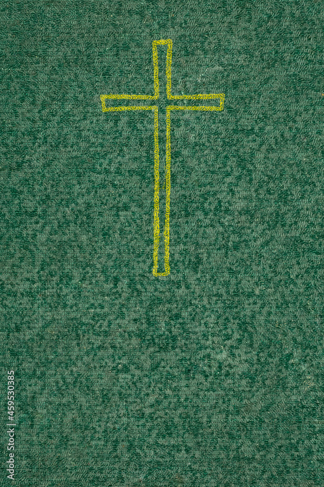 gold cross on a green background with a visible texture
