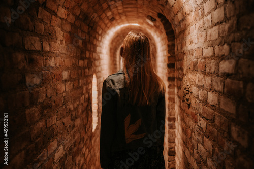 Old wine bottles dusting in an underground tratitional cellar. Small and old wine cellar with full wine bottles. Winery concept. Valtice Castle in South Moravia, Czech Republic, Europe photo