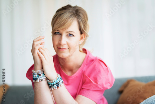 Beautiful middle aged woman portrait while relaxing at home