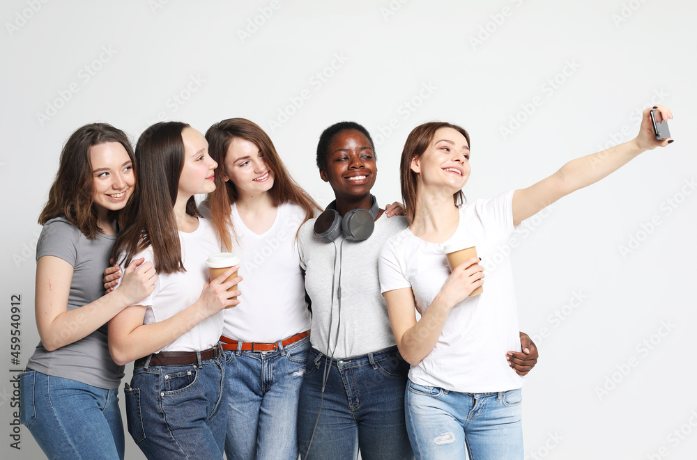 Obraz premium Diverse multi nation female group, african-american and caucasian teenage friends company make selfie