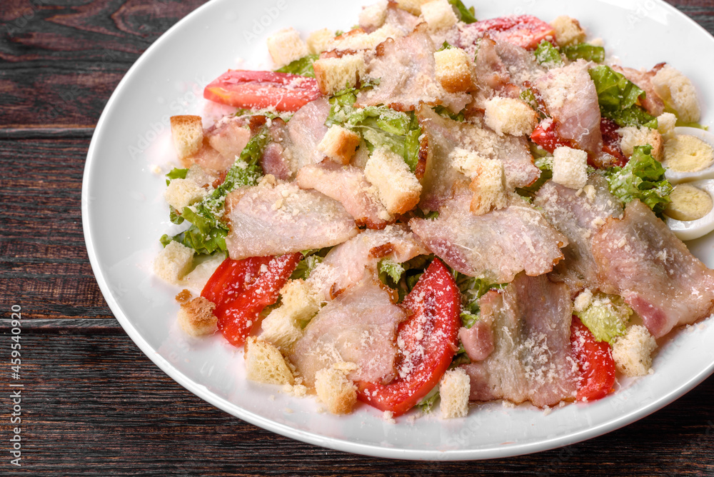 Delicious fresh salad with bacon and tomatoes with spices and greens Delicious fresh salad with bacon and tomatoes with spices and greens