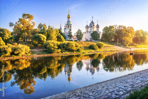 Kremlin temples and reflection in the river in Vologda in the light of a summer evening