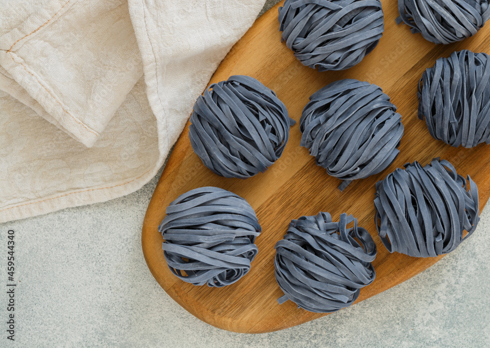 Raw organic wheat blue noodles with anchan flowers. The concept of a healthy and sporty lifestyle. butterfly pea flowers. Thai cuisine. Selective focus, Top view and Copy Space