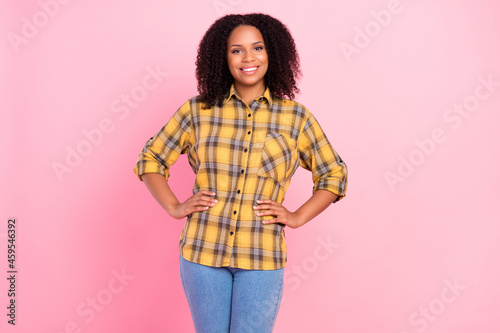 Photo of successful confident lady hands hips shiny smile wear checkered plaid shirt isolated pink color background