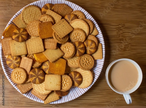 different types of decorated wheat biscuits also called food cracker famous as chai biscuit in india and pakistan served with tea mostly displayed in plate with a cup of tea top view, selective focus photo