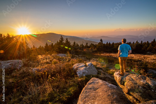Photography A hiker observing the sunset on the Blue Ridge Mountains in North Carolina