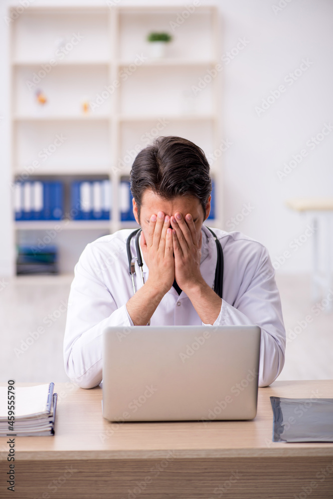Young male doctor working in the clinic Young male doctor working in the clinic