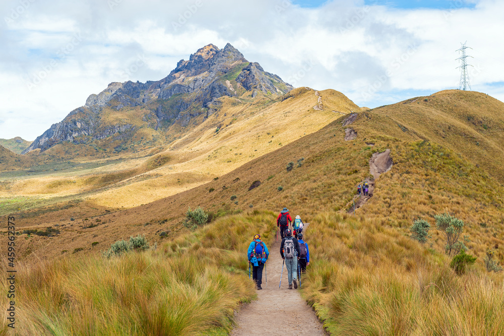 Small group of people with backpack hiking the Rucu Pichincha hike to the 4696m high Andes peak, Pichincha volcano, Quito, Ecuador.