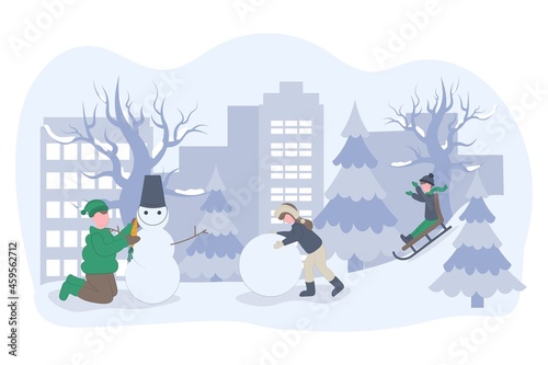 children playing in the snow, making snowman. Winter holidays. Active kids